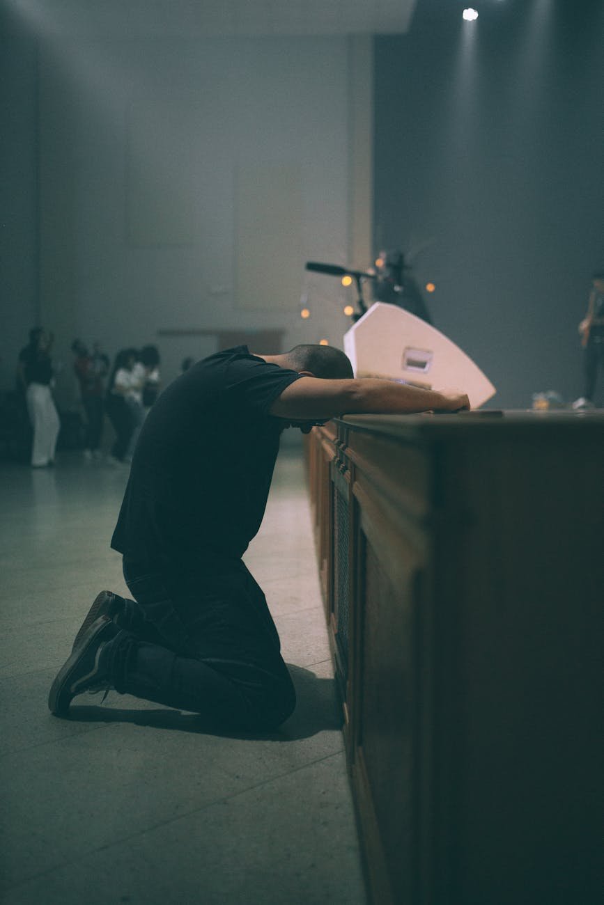 man kneeling in front of a stage